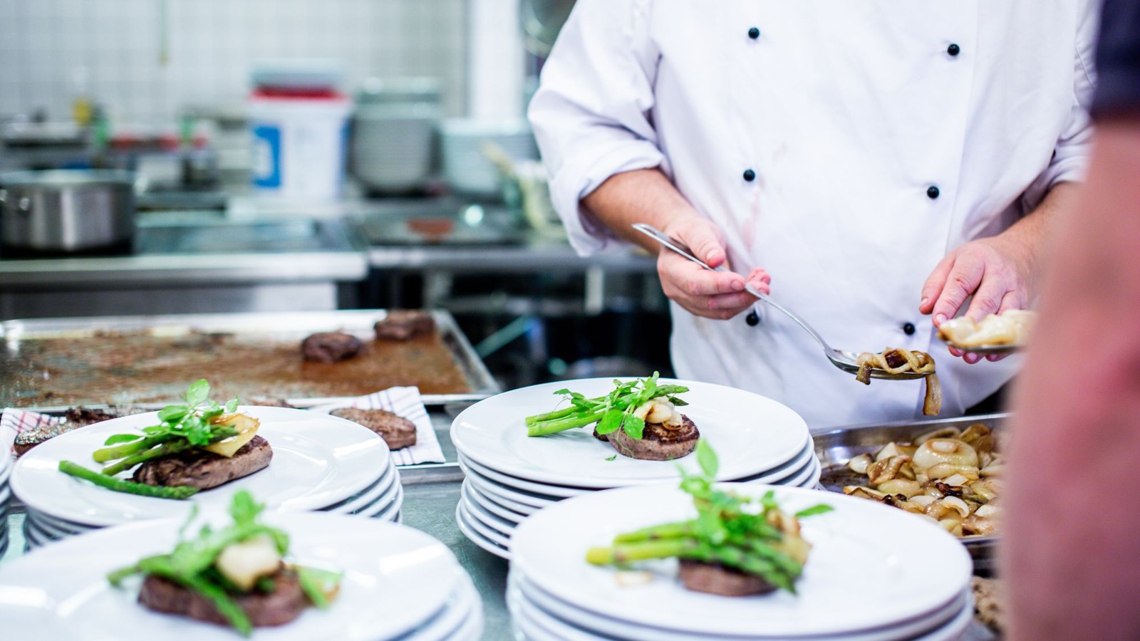 Chef plating food in a professional kitchen