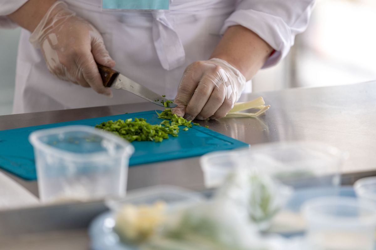 Chef preparing herbs in a professional kitchen